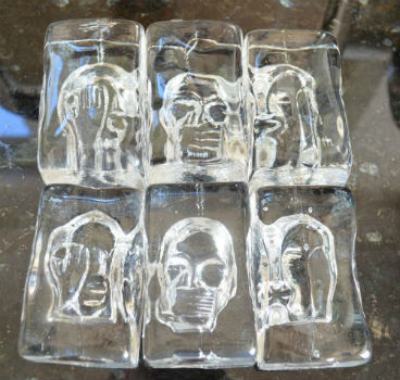 2 sets of blocks made by pouring molten glass onto a carved graphite face in a graphite box