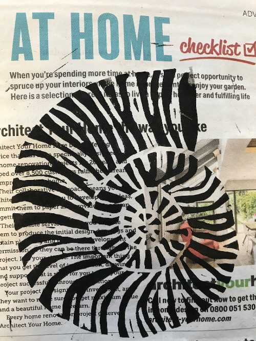 Linocut print of shell superimposed on a newspaper advert