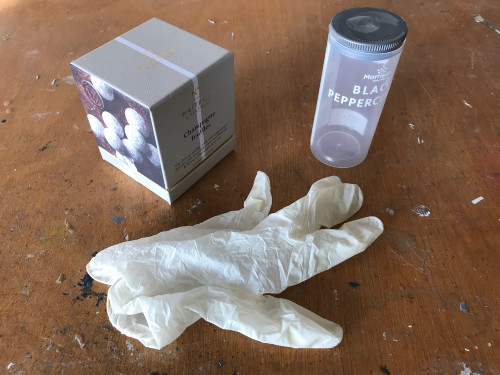 A box, cylindical container and latex glove