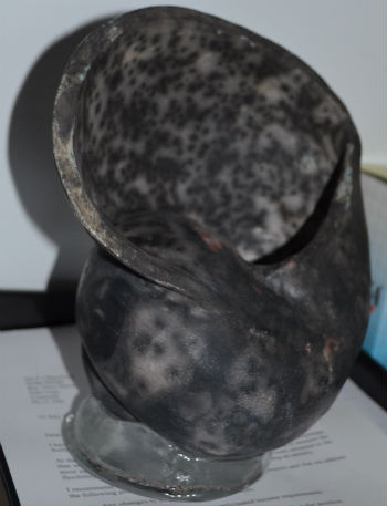 Dark colour after slip removed from raku fired shell