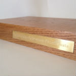 brass plaque in oak plinth